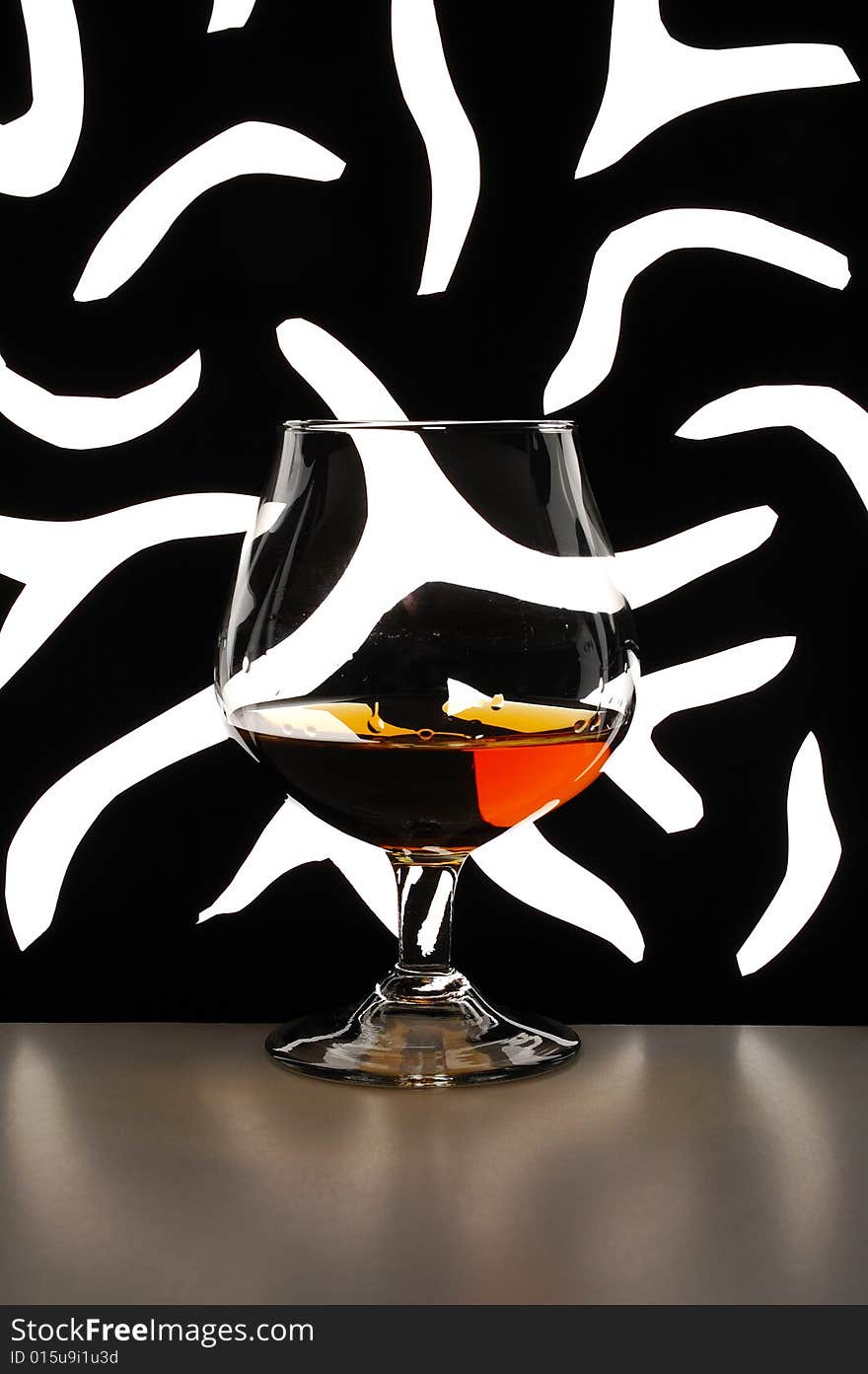 Glass of brandy against black-and-white background