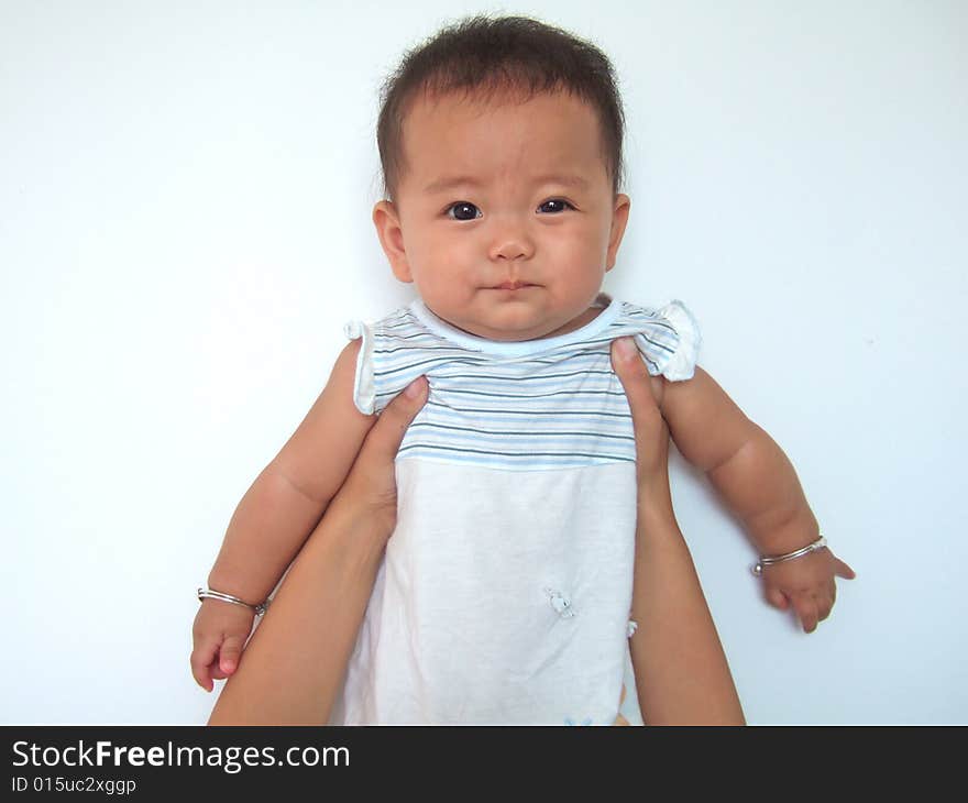 Cute baby raised up in mother's hand. Cute baby raised up in mother's hand