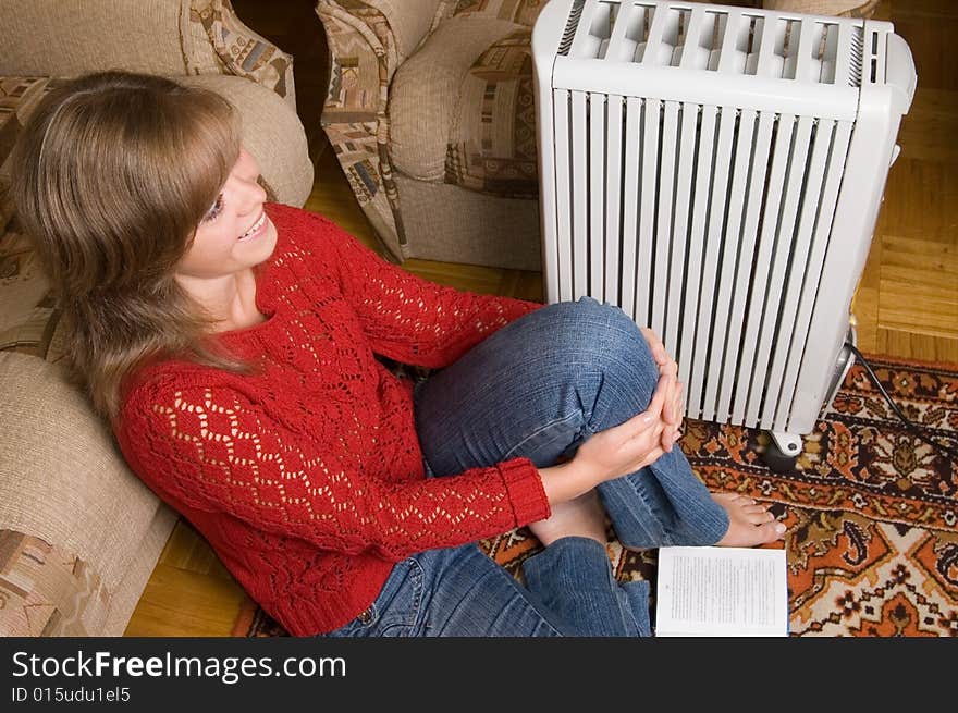 Woman sits on a carpet in a living room. Woman sits on a carpet in a living room