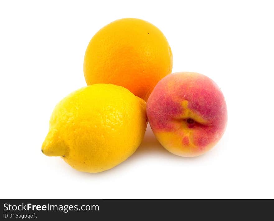 Beautiful useful tasty fruit lemon orange and peach on white background