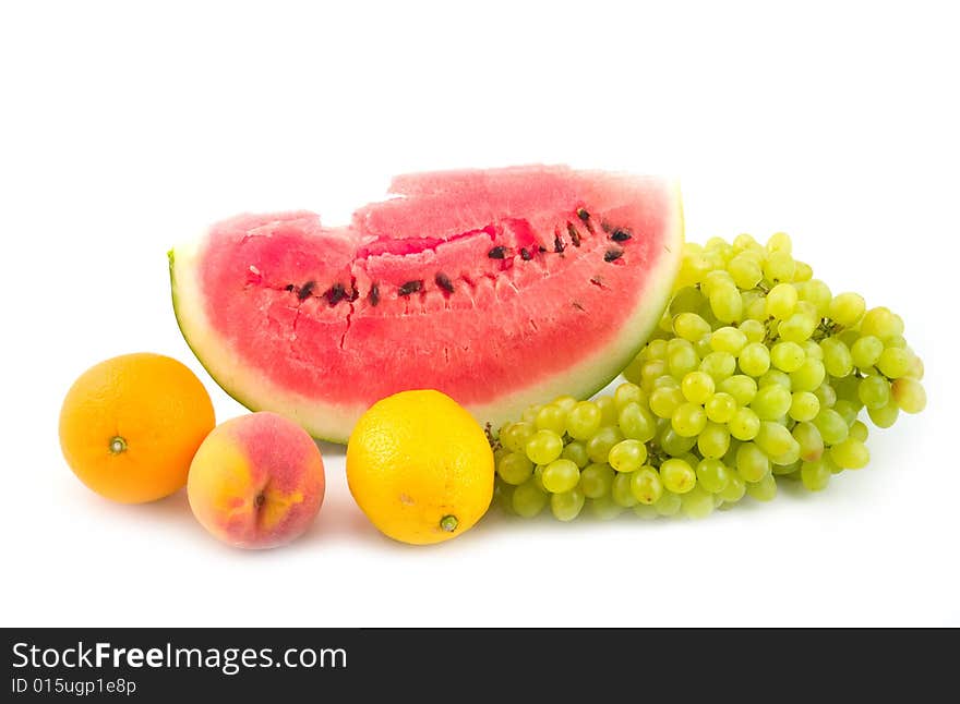 Watermelon and grapes peach orange lemon ripe fruit on white background