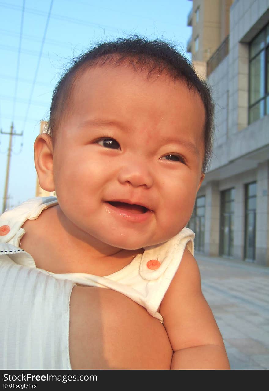 Happy baby on her mother's shoulder