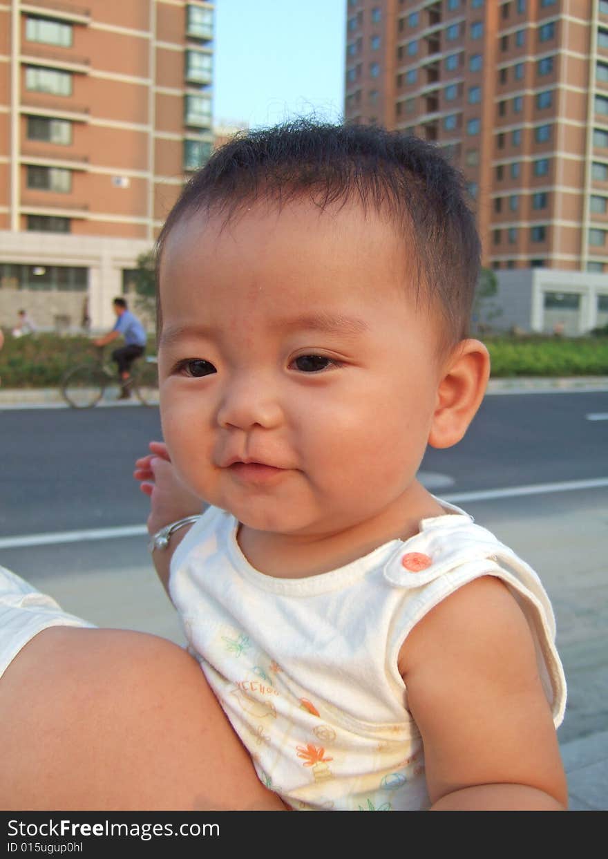 Happy baby on her mother's shoulder. Happy baby on her mother's shoulder