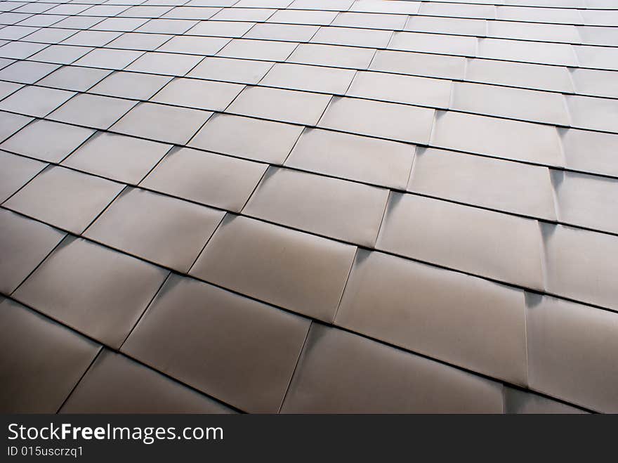 Steel panels on the outside of a building with arch patterns in the metal