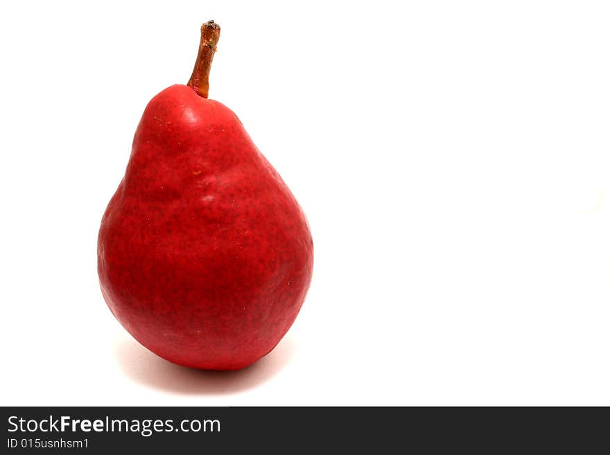 A red pear isolated on a white background.