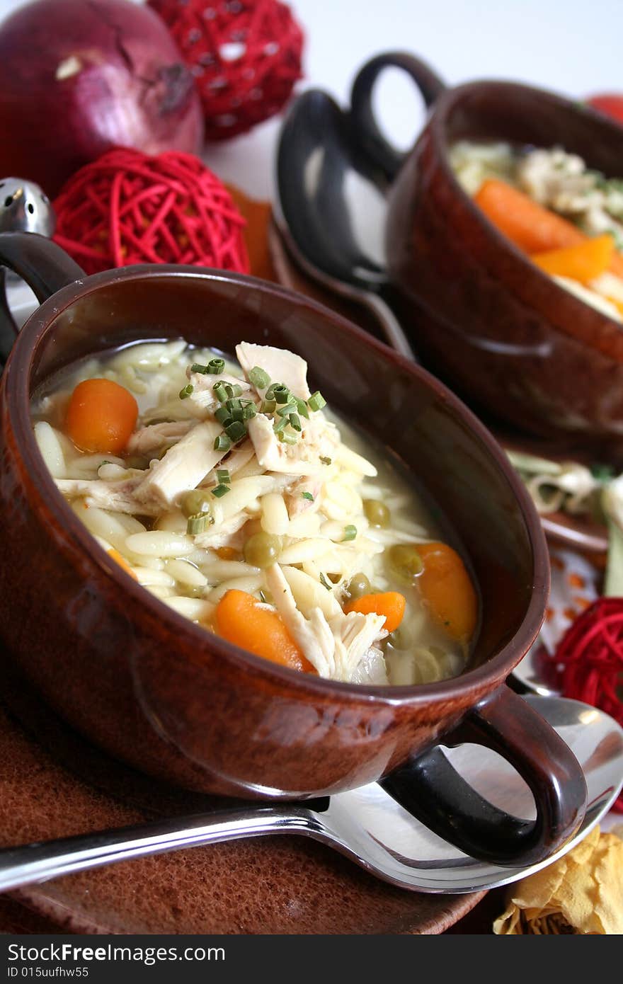 A stew of rice, chicken and some fresh vegetables. A stew of rice, chicken and some fresh vegetables