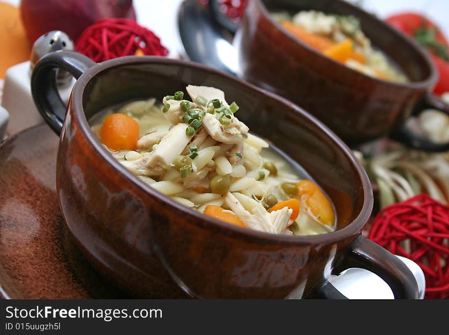 A stew of rice, chicken and some fresh vegetables. A stew of rice, chicken and some fresh vegetables