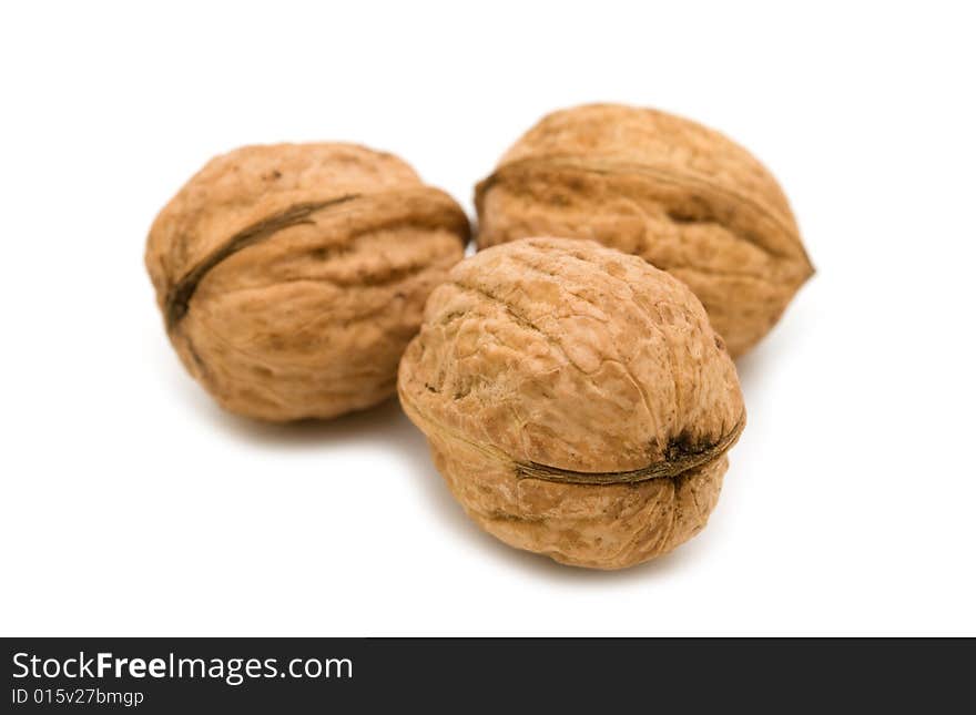 Three walnuts on white background