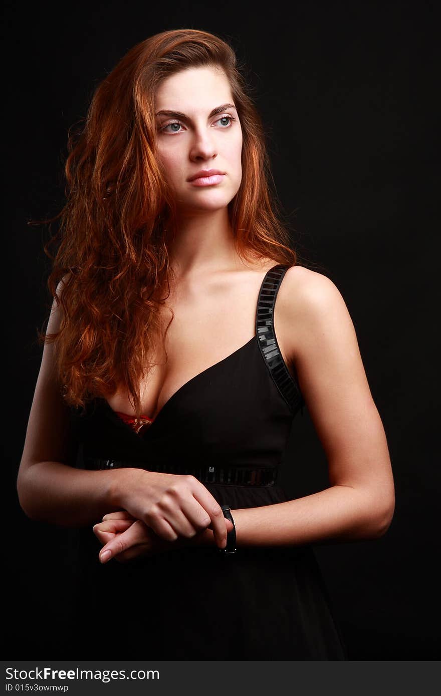 Portrait of beautiful woman over black background