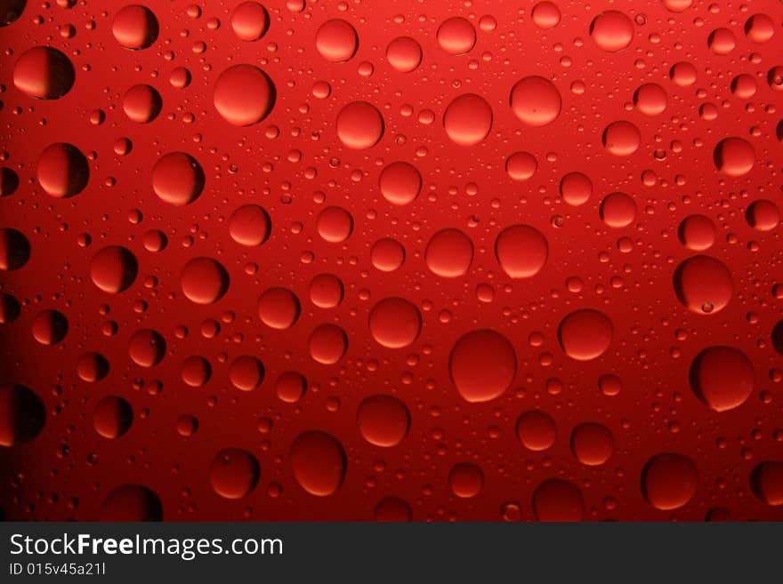 The red water drop on smooth surface. The red water drop on smooth surface