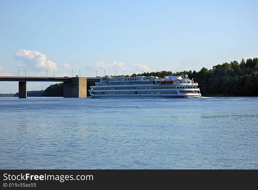 The motor ship on  the river at the bridge