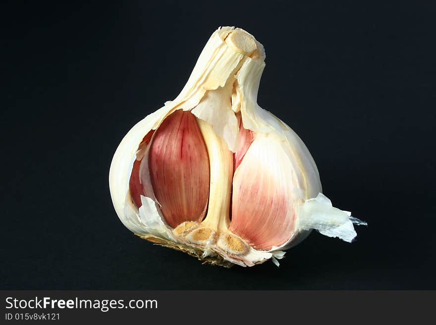 A garlic bulb isolated on a black background