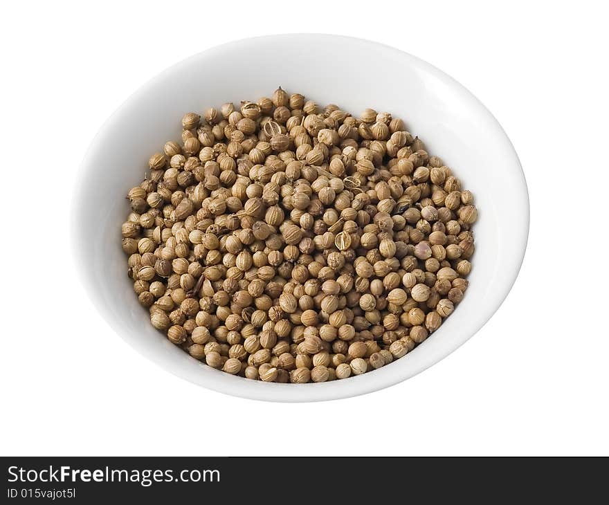 Kitchen utensil with dried coriander on a white background (isolated with path). Kitchen utensil with dried coriander on a white background (isolated with path).