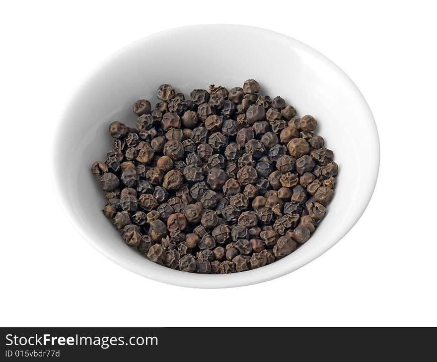 Kitchen utensil with dried black peppers on a white background (isolated with path). Kitchen utensil with dried black peppers on a white background (isolated with path).