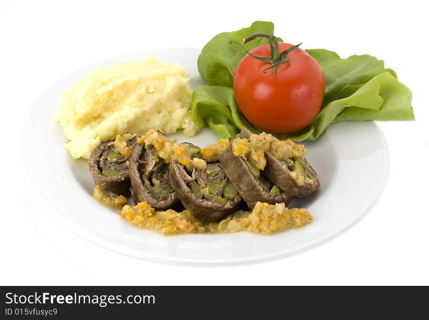 Roulade with mashed potatoes on a white plate