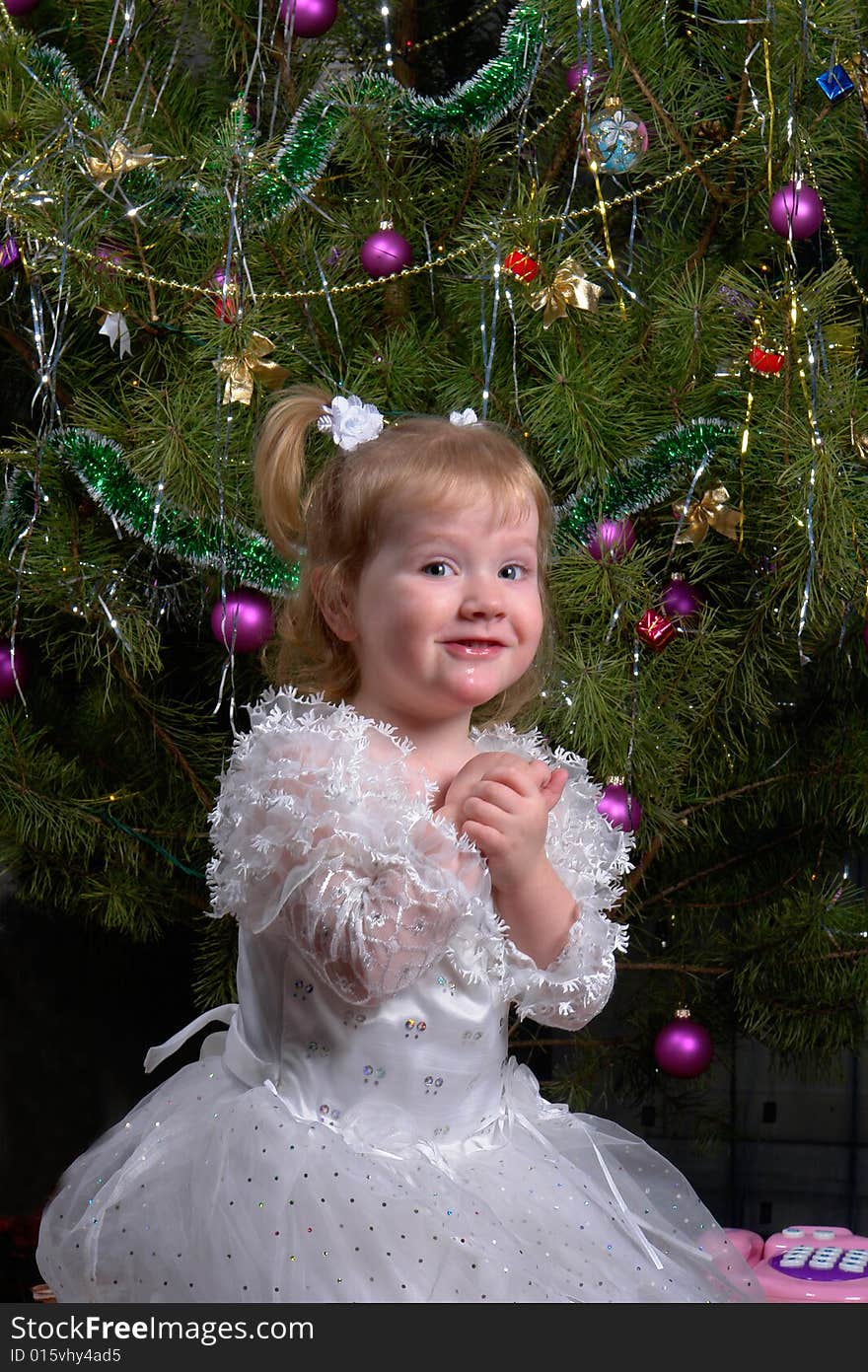 Girl on a background of a New Year tree