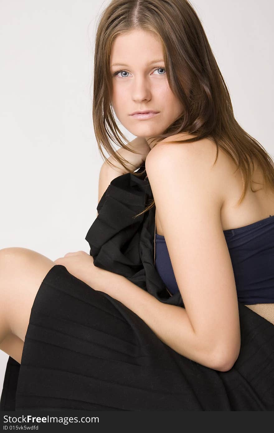 Portrait of young beautiful sad woman on white background