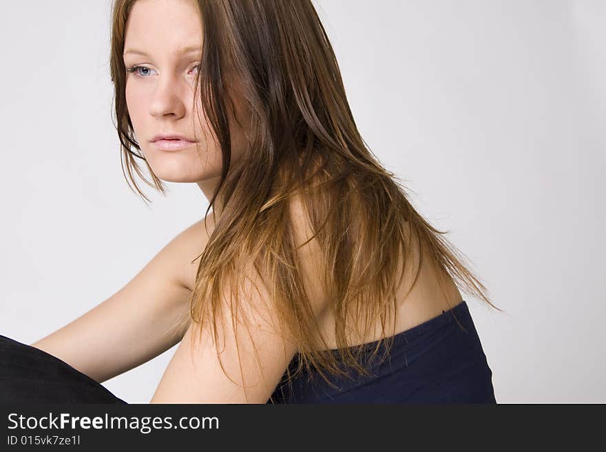 Portrait of young beautiful sad woman on white background