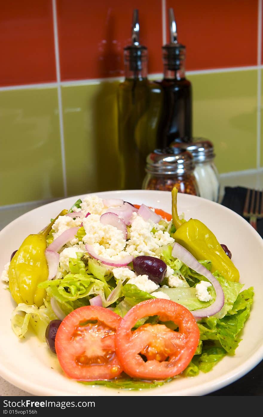 An image of Greek style pizza with artichokes and chicken