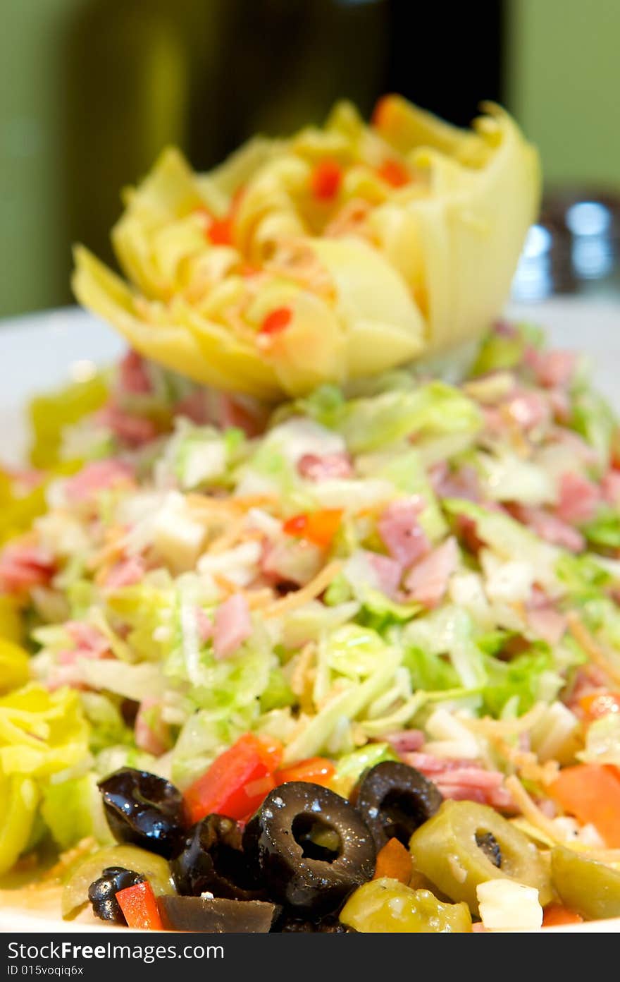 An image of Greek style pizza with artichokes and chicken