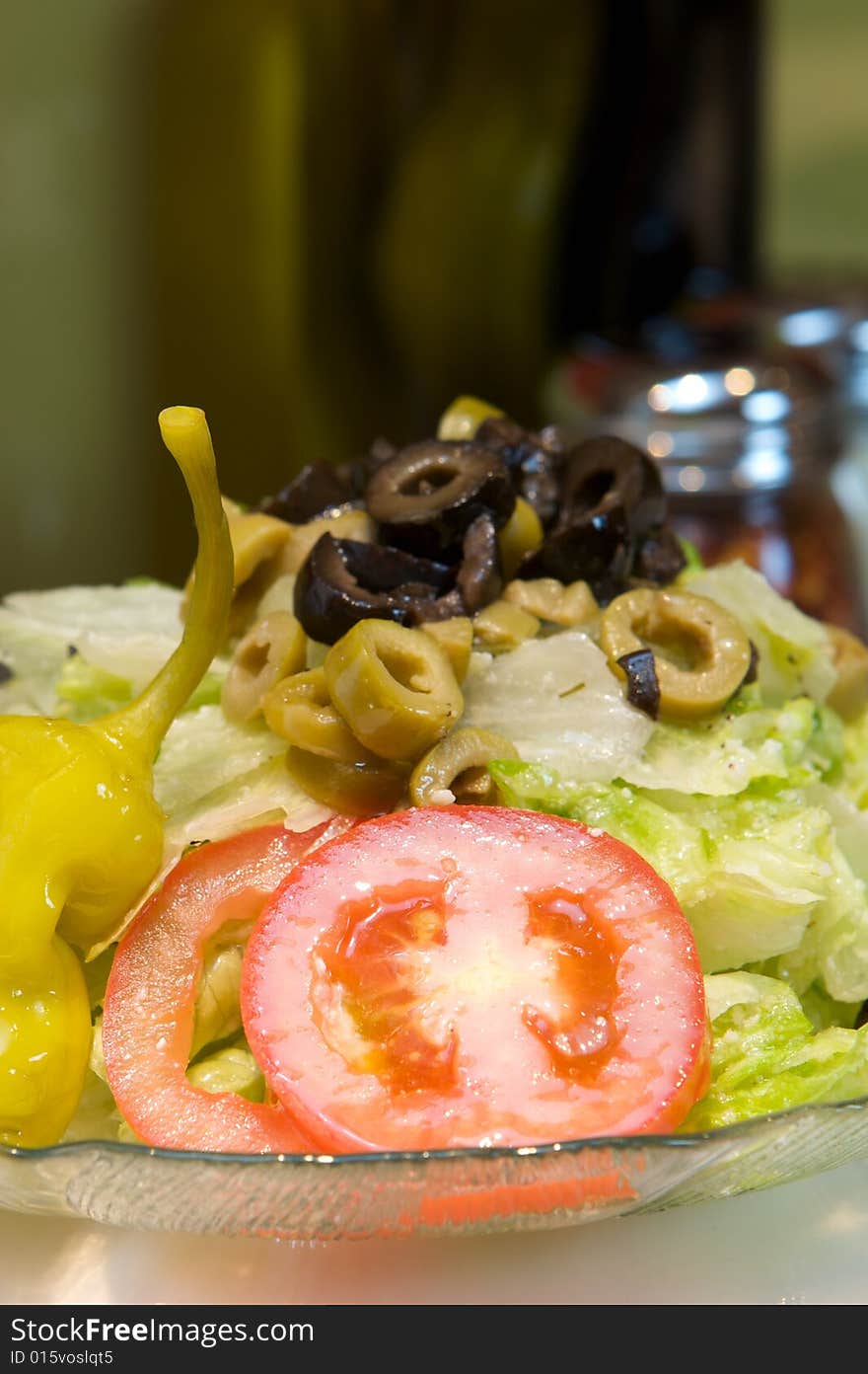 An image of Greek style pizza with artichokes and chicken