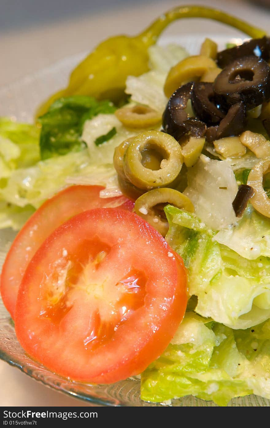 An image of Greek style pizza with artichokes and chicken