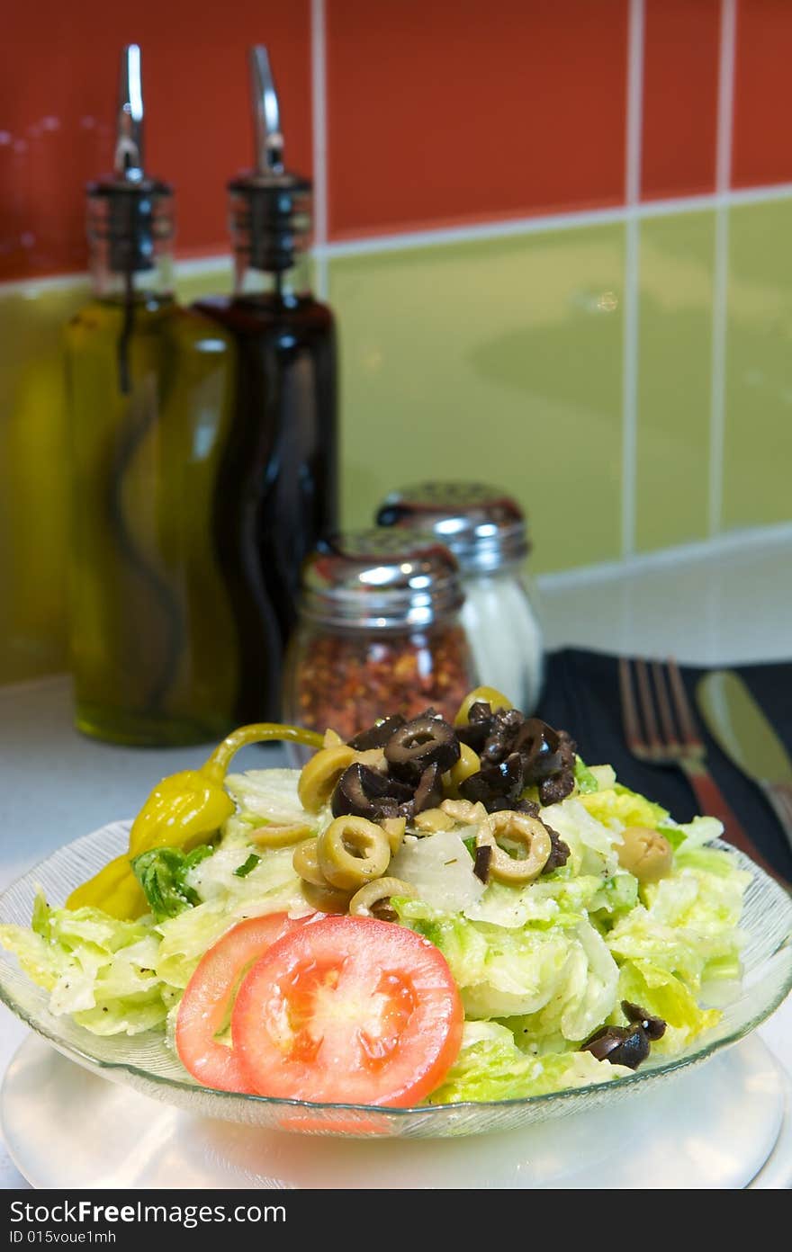 An image of Greek style pizza with artichokes and chicken