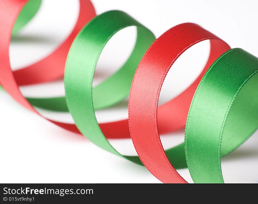 Red and green ribbon curling on white background. Red and green ribbon curling on white background