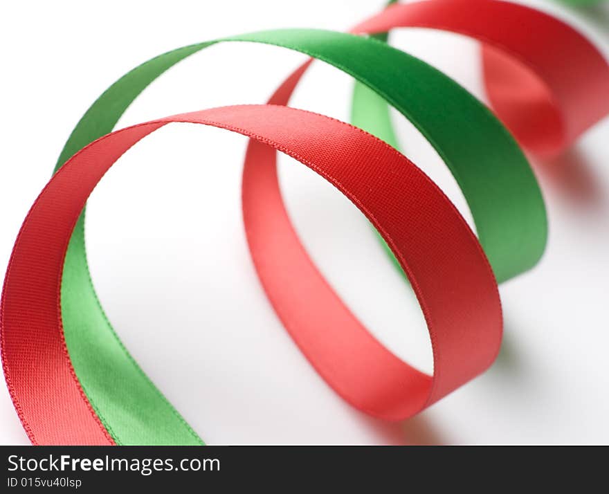 Red and green ribbon curling on white background. Red and green ribbon curling on white background