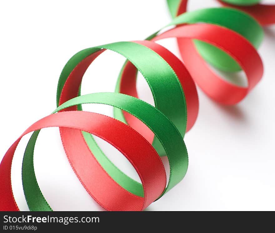 Red and green ribbon curling on white