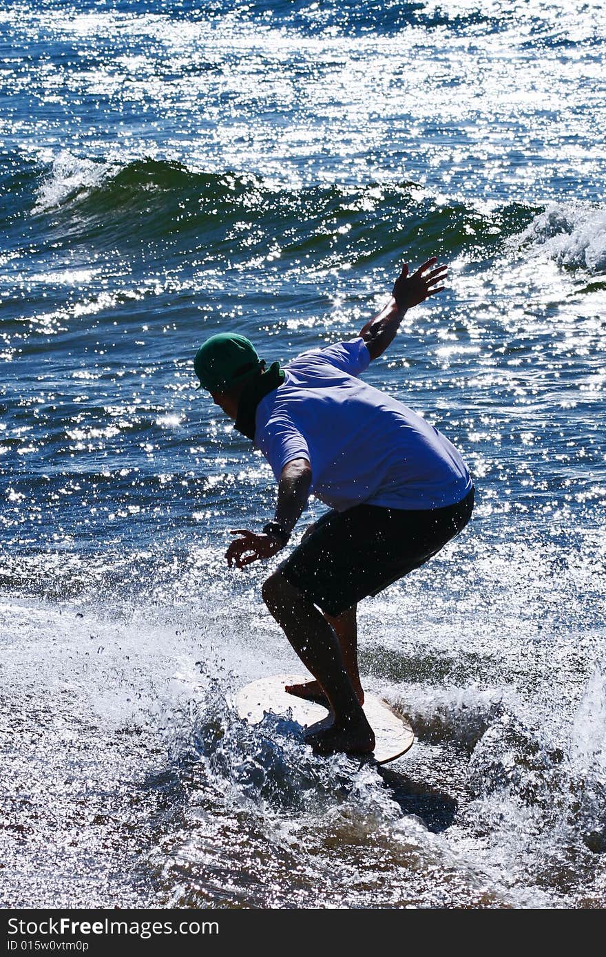 Skimboarder on the Baltic beach. Skimboarder on the Baltic beach