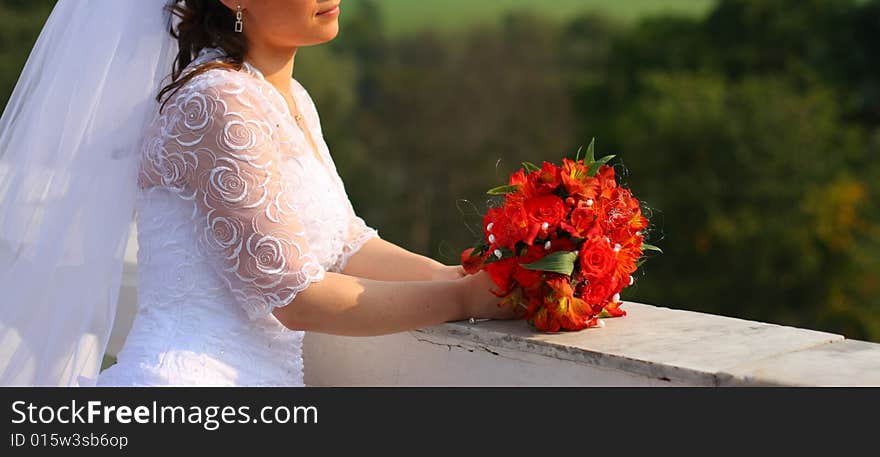 Bride with the bunch of flowers. Sun weather. Bride with the bunch of flowers. Sun weather