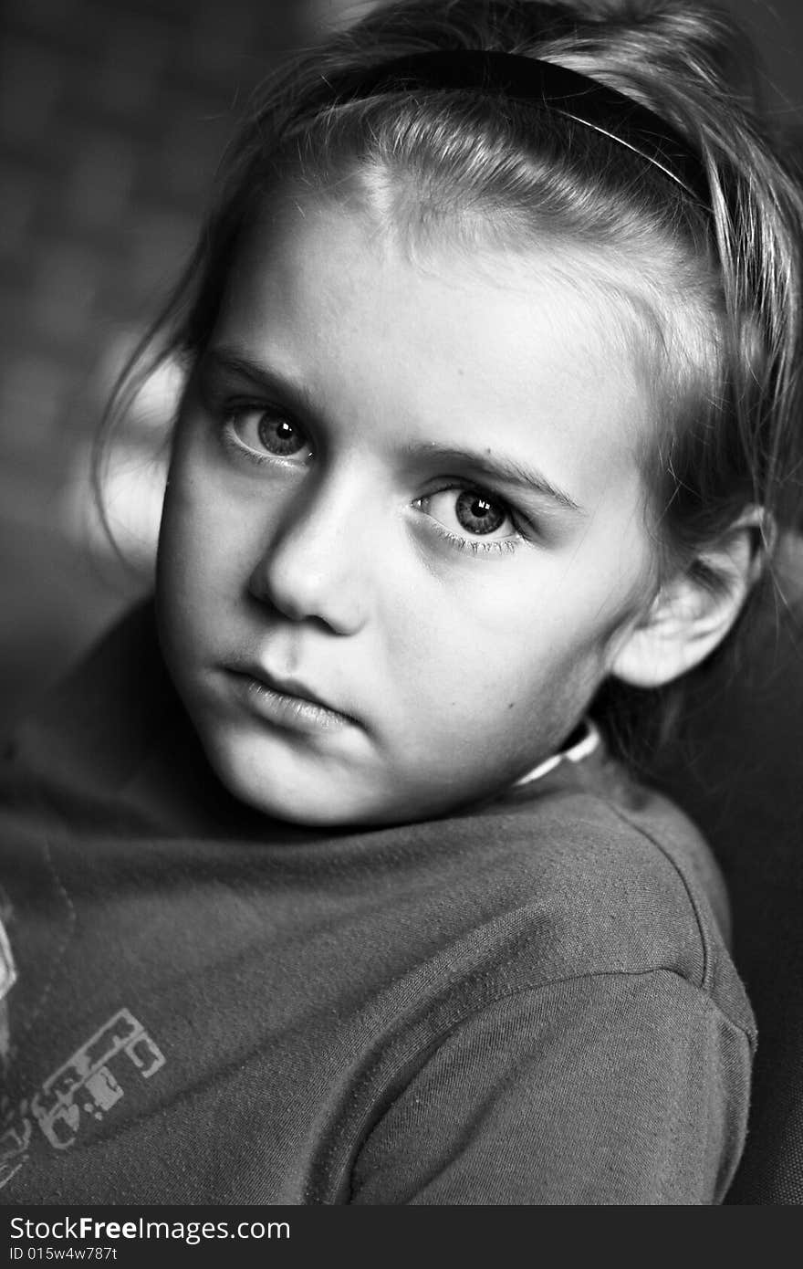 Portrait of boy in black and white with big eyes.