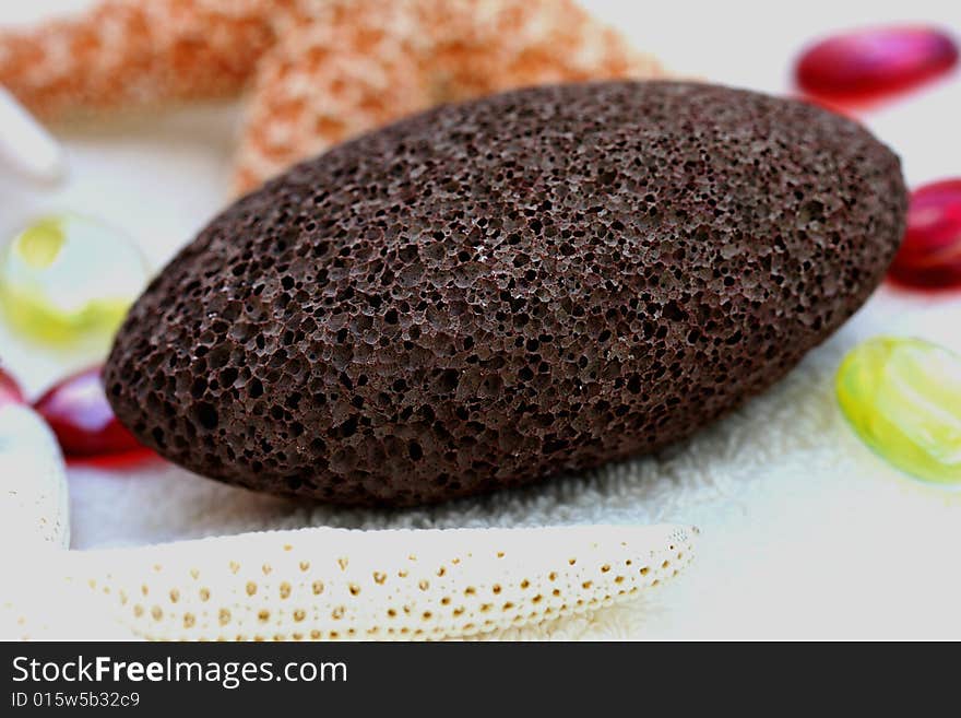 A closeup of spa and massage items (pumice, sponge,towel). A closeup of spa and massage items (pumice, sponge,towel)