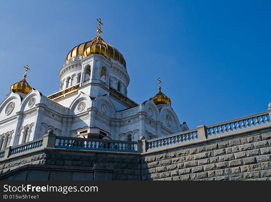 Majestic Temple of the Christ of the Savior under the blue sky with gold domes and crosses on them. Majestic Temple of the Christ of the Savior under the blue sky with gold domes and crosses on them