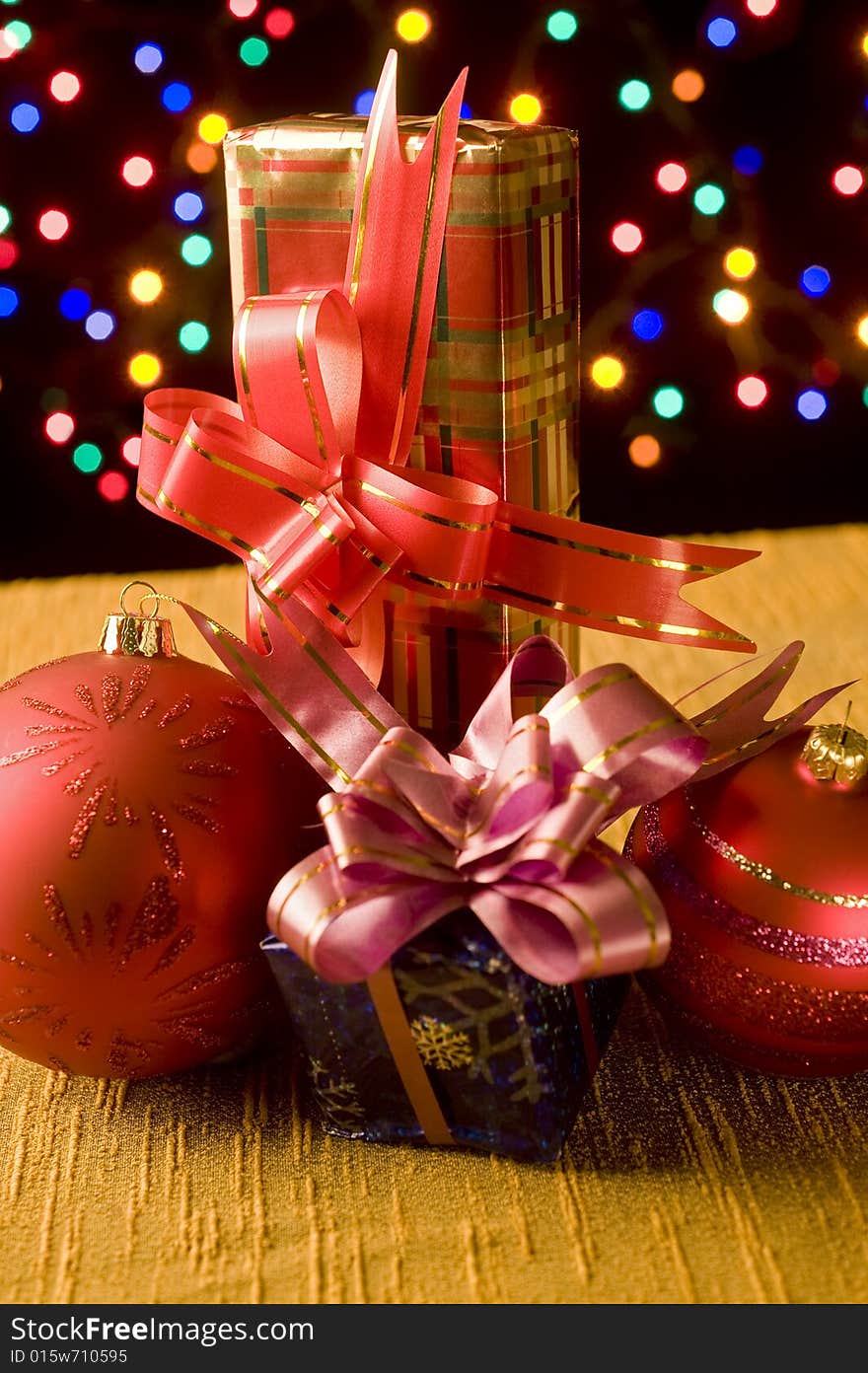 Christmas still life with presents, balls decoration and out of focus lights