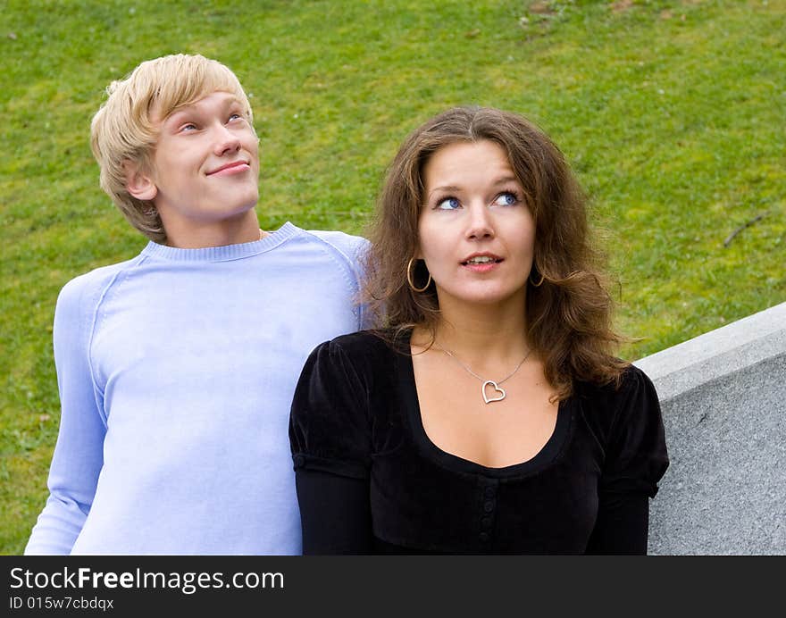 Young Couple In Meadow Looking Up