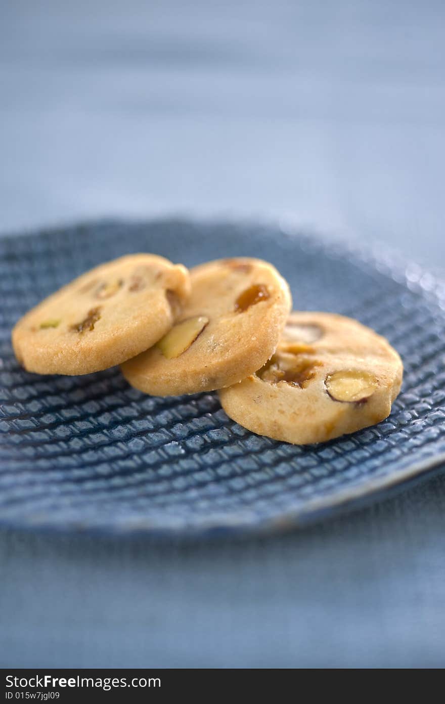 Three homemade cookies on a blue ceramic plate