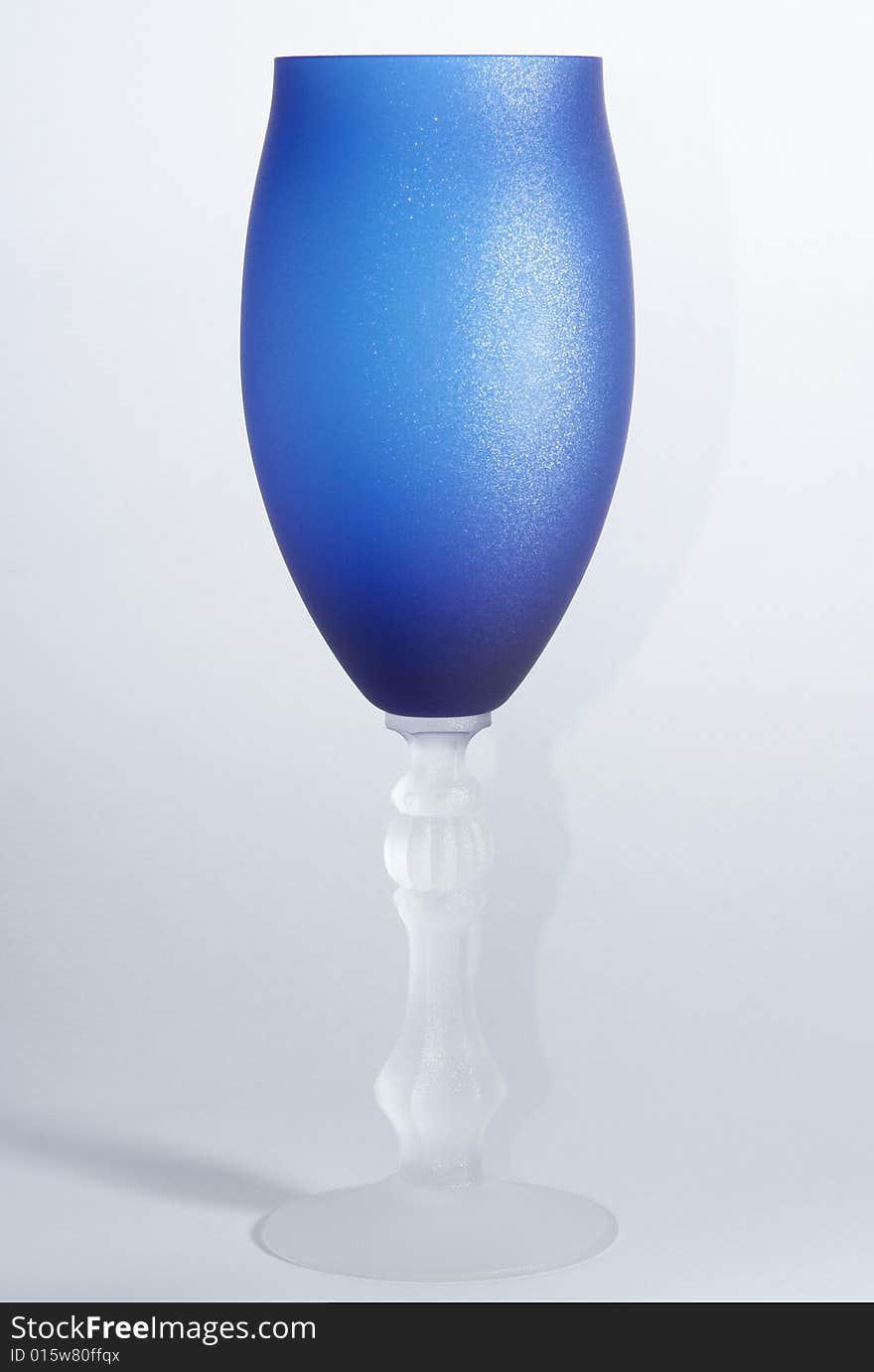 Blue wineglass on the white background