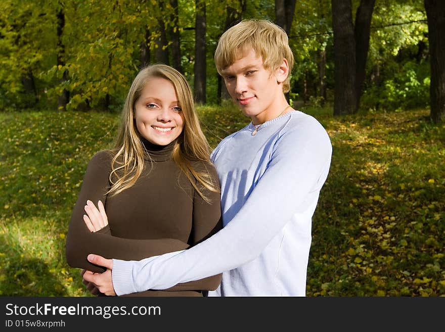 Handsome boy embracing his attractive girlfriend. outdoor