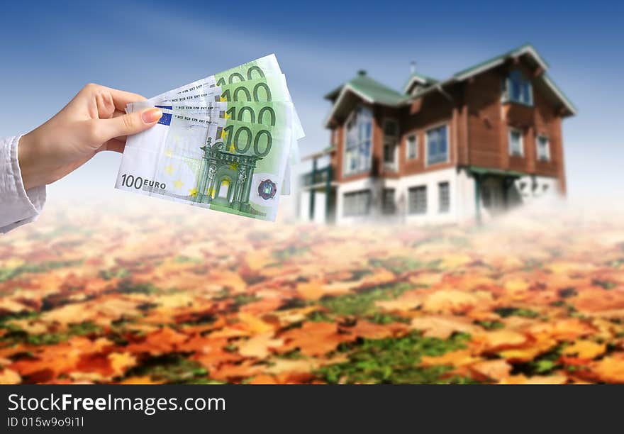 Woman's hands with euro money. House on the background. Buying house concept. Woman's hands with euro money. House on the background. Buying house concept.