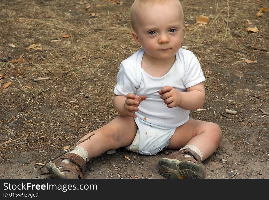 Cute 1 year old baby boy in sitting in park. Cute 1 year old baby boy in sitting in park