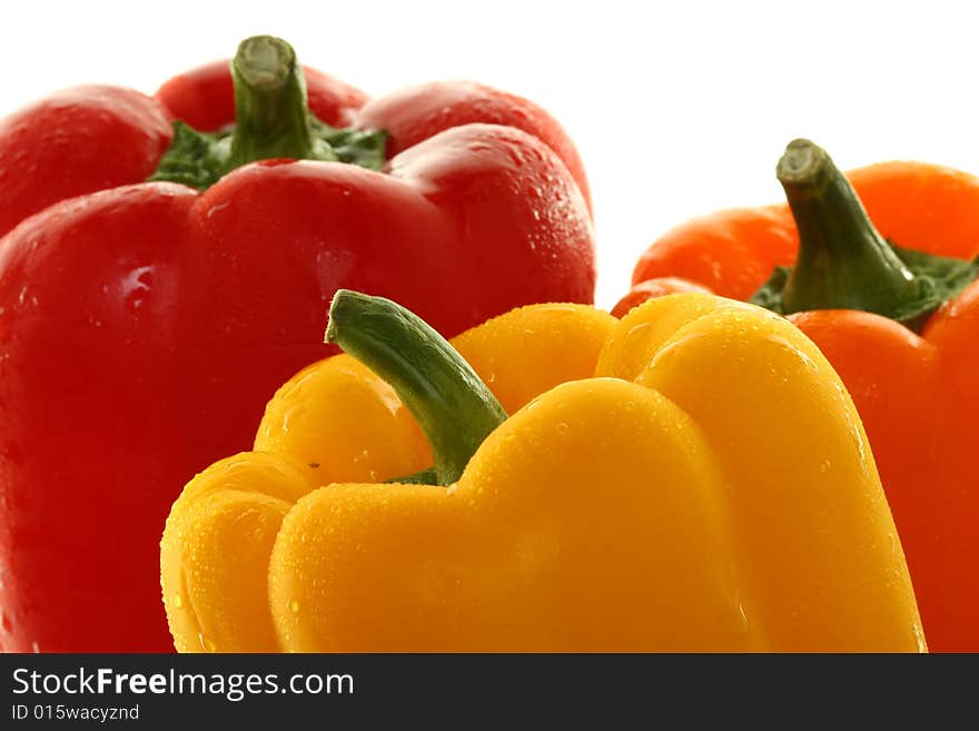 Yellow, Red and Orange bell peppers in a group, Isolated on White, closeup by stems. Yellow, Red and Orange bell peppers in a group, Isolated on White, closeup by stems