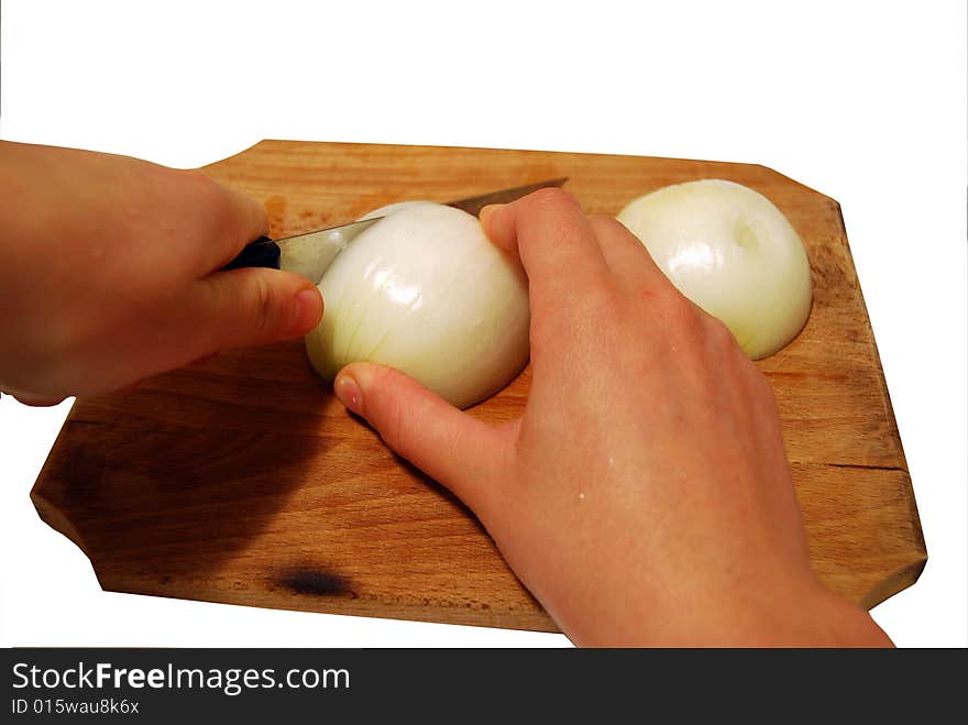 Hands hand cutting onion on a wooden table and white background. cooking activities. Hands hand cutting onion on a wooden table and white background. cooking activities.