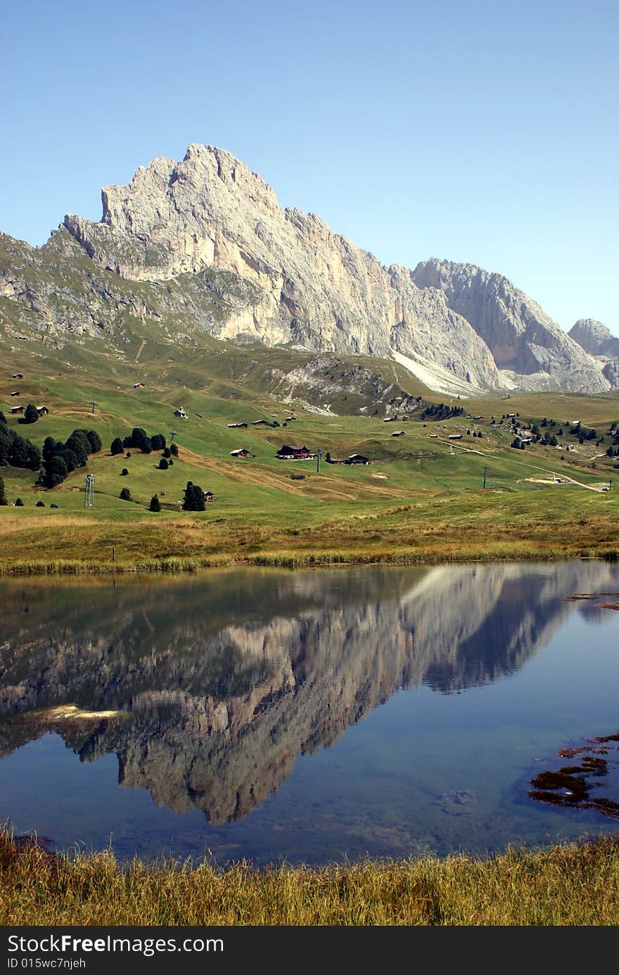 Mountains and trees reflected in a lake situated in the Dolimites, Italy. Mountains and trees reflected in a lake situated in the Dolimites, Italy