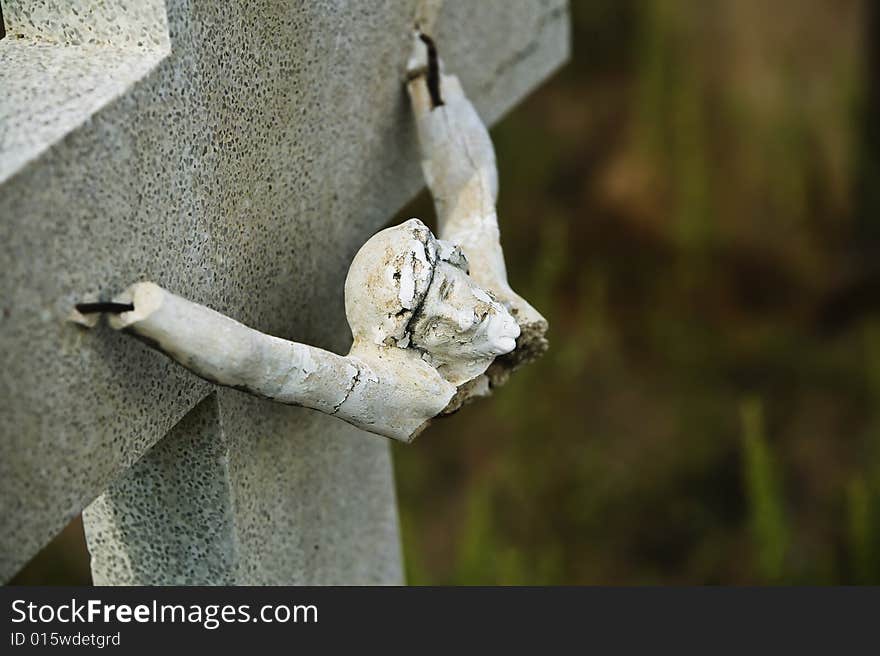 Broken figure of jesus Christ on a grave marker. Broken figure of jesus Christ on a grave marker