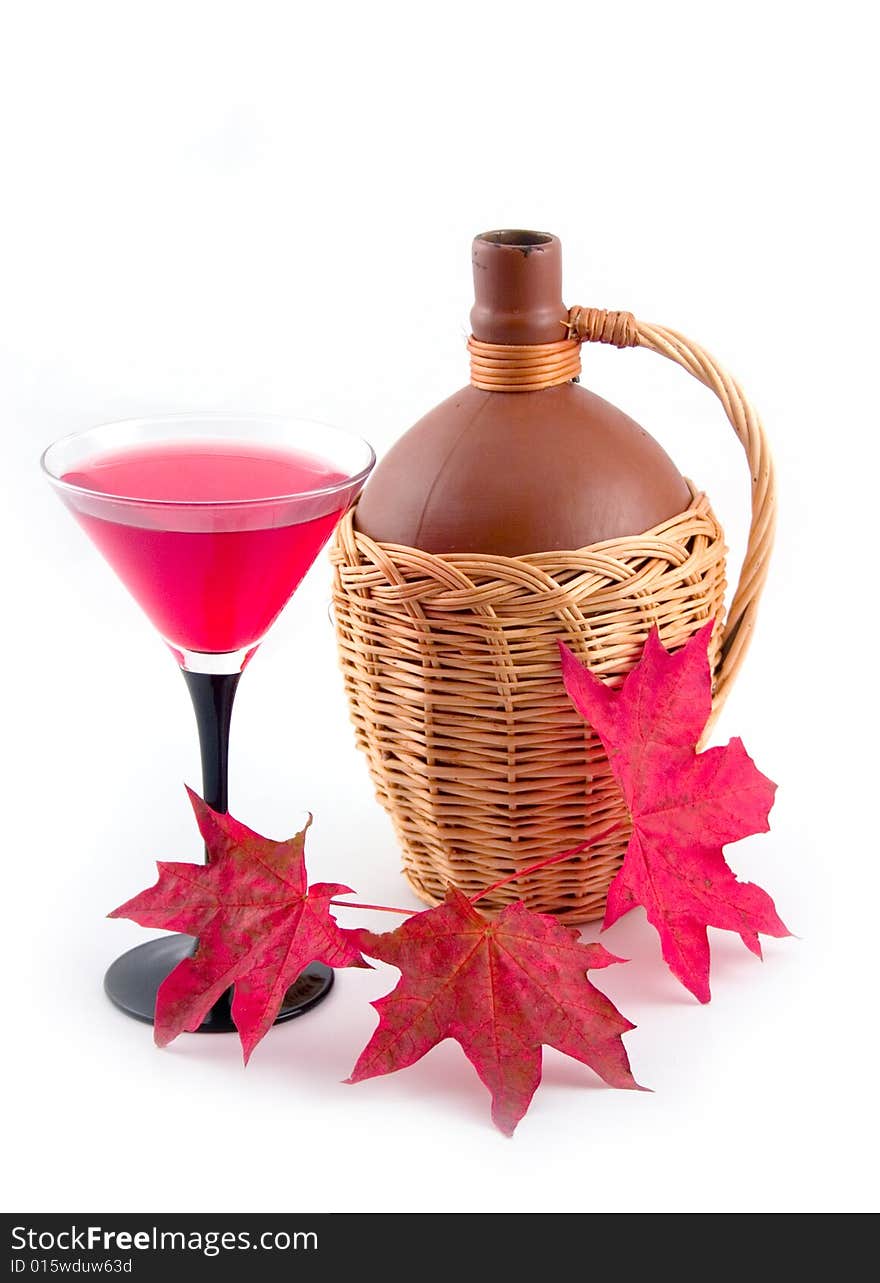 Bottle fault in yellow basket and red maple leaves on white background