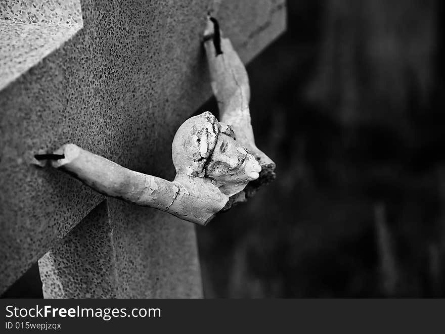 Broken figure of jesus Christ on a grave marker. Broken figure of jesus Christ on a grave marker