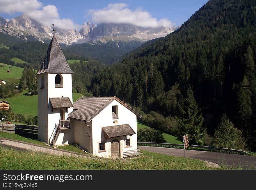 White church in a valley in the Dolomites, Italy. White church in a valley in the Dolomites, Italy