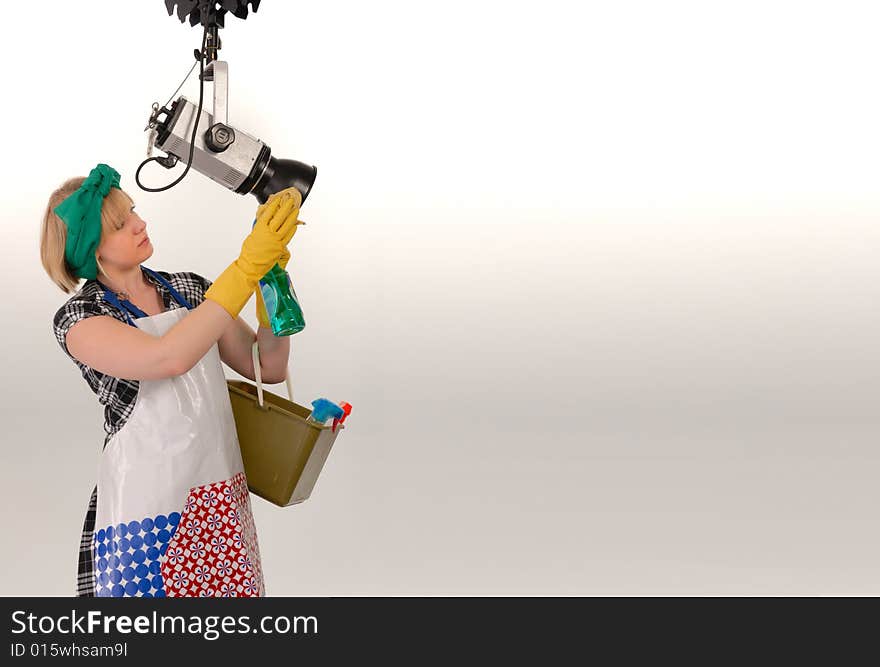 Woman cleaning photo studio with space for rtext, humorous concept